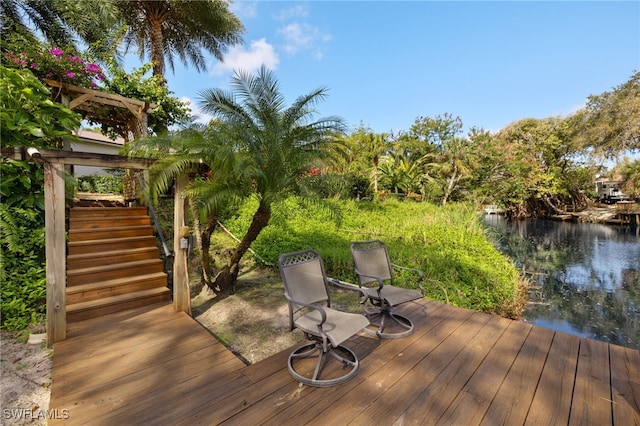 wooden terrace featuring stairs and a water view