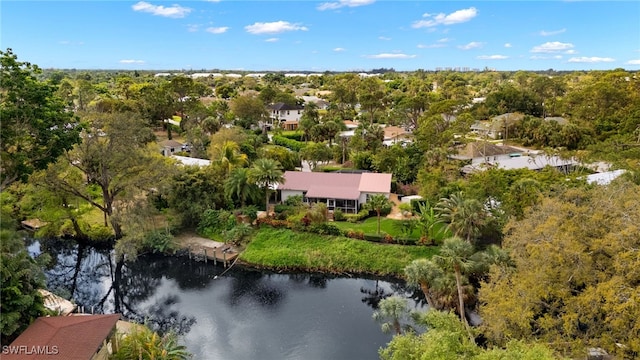 drone / aerial view featuring a forest view and a water view