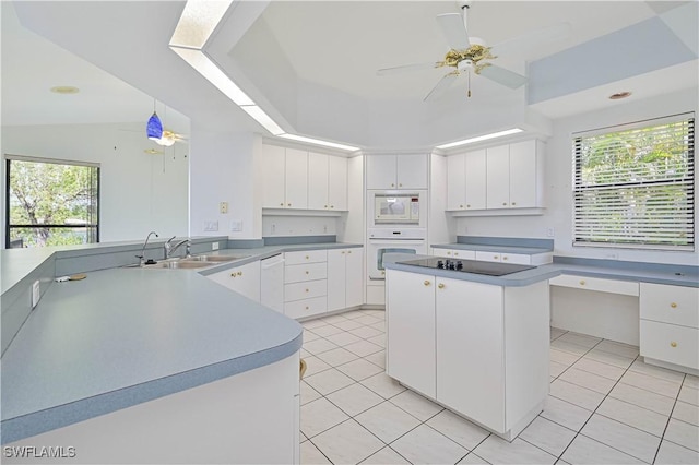 kitchen featuring white appliances, ceiling fan, plenty of natural light, and a sink