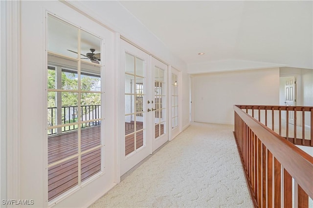 hallway featuring carpet floors, recessed lighting, and french doors