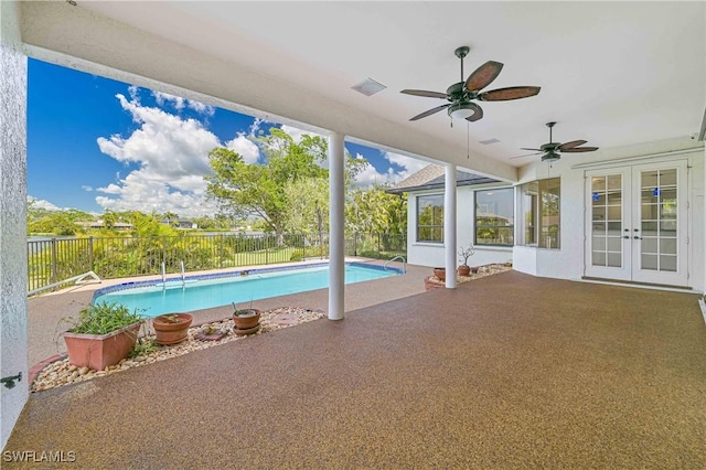 view of pool featuring a fenced in pool, french doors, a patio, ceiling fan, and a fenced backyard