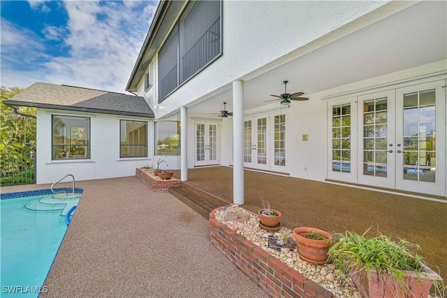 view of patio featuring french doors, a ceiling fan, and an outdoor pool