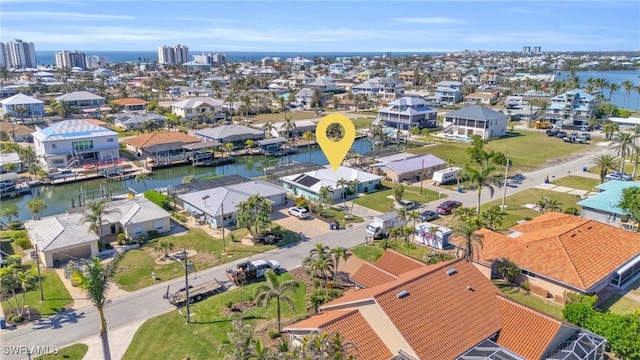 birds eye view of property with a water view and a residential view