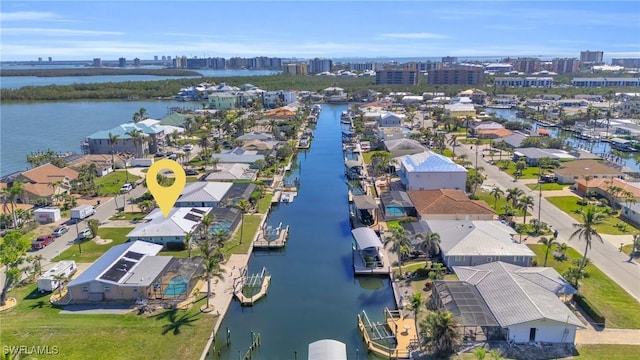 birds eye view of property with a water view and a view of city