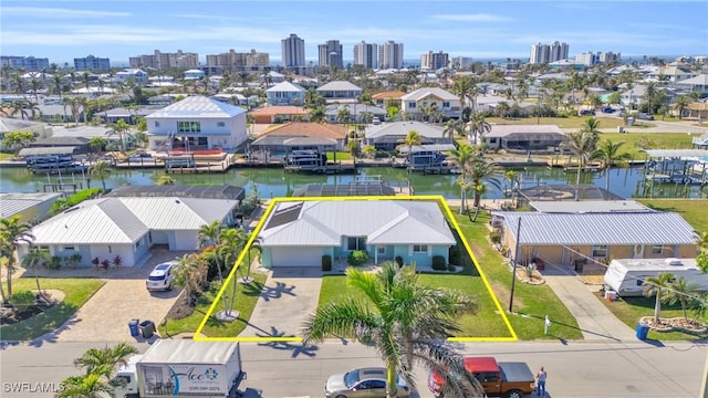 drone / aerial view with a water view, a residential view, and a city view