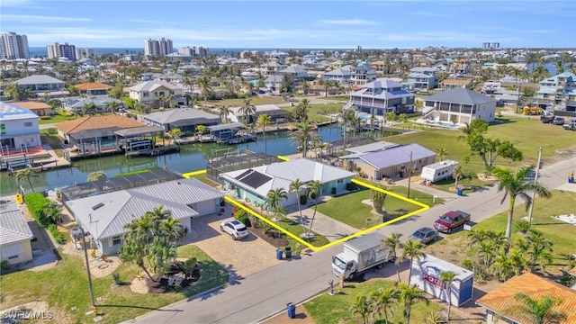 birds eye view of property featuring a water view and a residential view