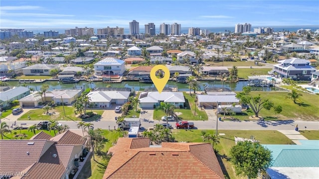 birds eye view of property with a water view and a city view