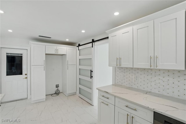 8 Bayview Blvd, Fort Myers Beach, FL 33931 - kitchen with a barn door, recessed lighting, marble finish floor, light stone counters, and white cabinets
