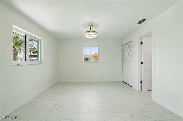 8 Bayview Blvd, Fort Myers Beach, FL 33931 - empty room with baseboards, marble finish floor, and visible vents