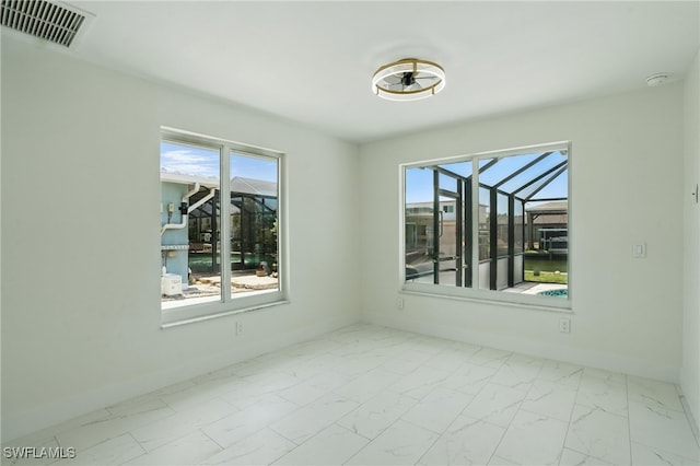 8 Bayview Blvd, Fort Myers Beach, FL 33931 - spare room with marble finish floor, plenty of natural light, baseboards, and visible vents