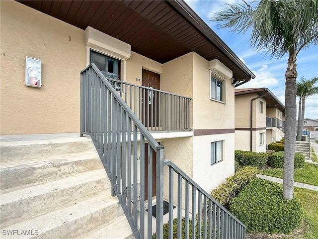 view of exterior entry featuring stucco siding