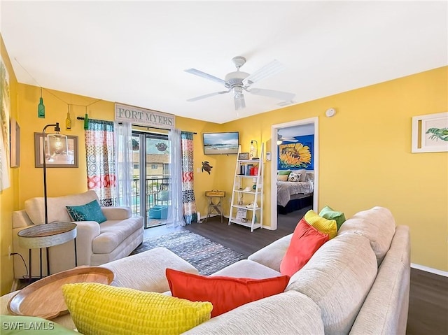 living area with ceiling fan, baseboards, and wood finished floors