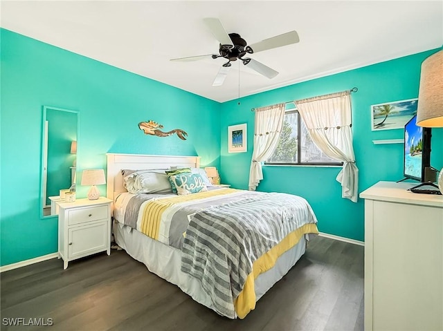 bedroom with dark wood-style flooring, ceiling fan, and baseboards