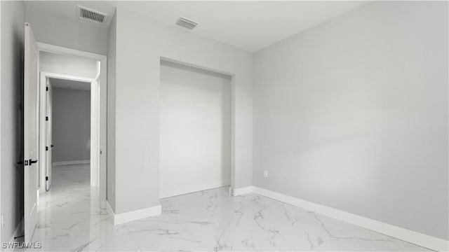 unfurnished bedroom featuring baseboards, visible vents, and marble finish floor