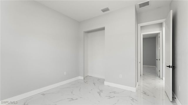 unfurnished bedroom featuring visible vents, baseboards, and marble finish floor