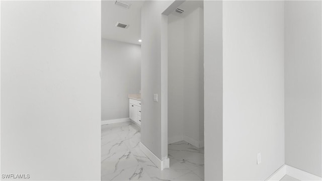 bathroom featuring visible vents, marble finish floor, vanity, and baseboards