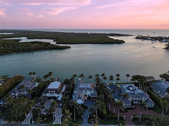 drone / aerial view featuring a residential view and a water view