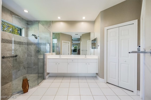 bathroom featuring double vanity, a tile shower, recessed lighting, tile patterned floors, and a sink