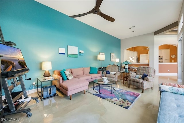 living room with arched walkways, visible vents, baseboards, and ceiling fan