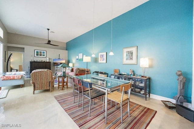 dining area with baseboards and a ceiling fan