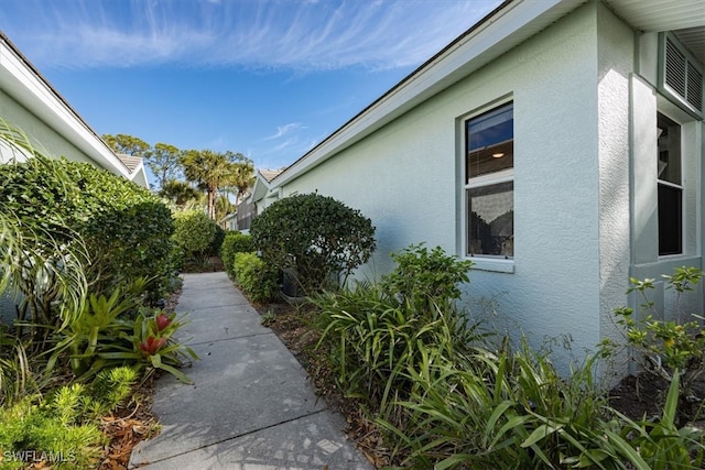 view of side of property with stucco siding