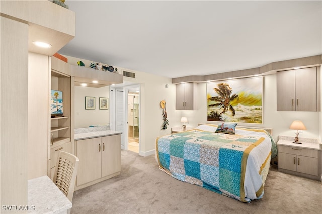 bedroom featuring baseboards, visible vents, ensuite bathroom, and light colored carpet