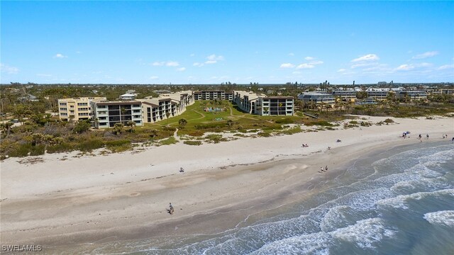 bird's eye view with a water view and a beach view