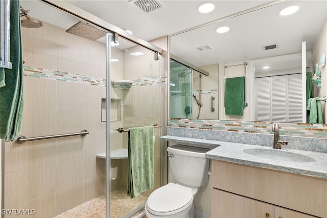 bathroom with vanity, visible vents, and a shower stall