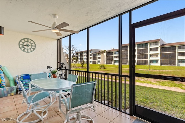 sunroom featuring ceiling fan