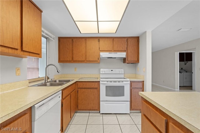 kitchen with light countertops, white appliances, a sink, and under cabinet range hood