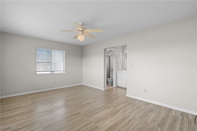 unfurnished room with light wood-type flooring, baseboards, and a ceiling fan