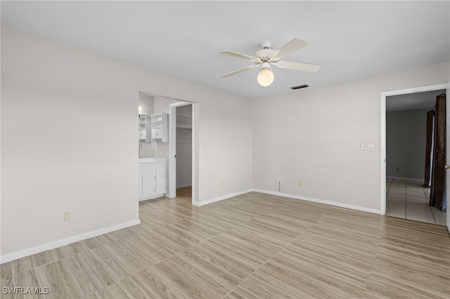 unfurnished room featuring visible vents, ceiling fan, and baseboards