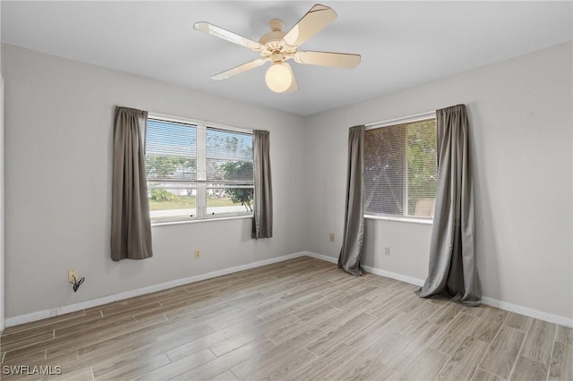 unfurnished room featuring baseboards, a healthy amount of sunlight, a ceiling fan, and light wood-style floors