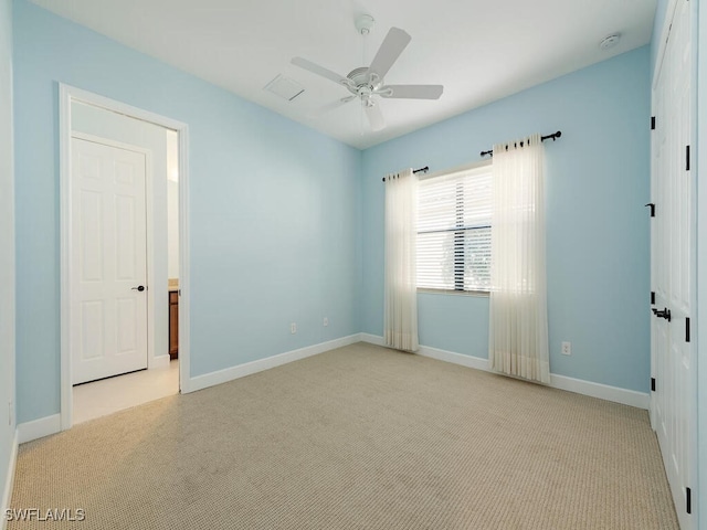 spare room featuring ceiling fan, baseboards, and carpet flooring