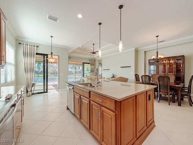 kitchen with a sink, visible vents, ornamental molding, appliances with stainless steel finishes, and light stone countertops