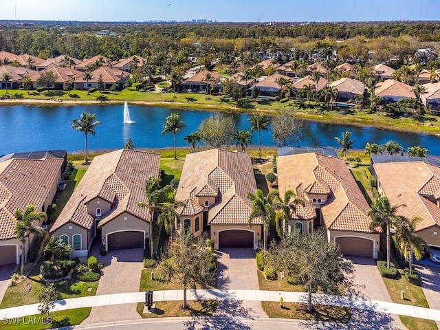 birds eye view of property with a residential view and a water view