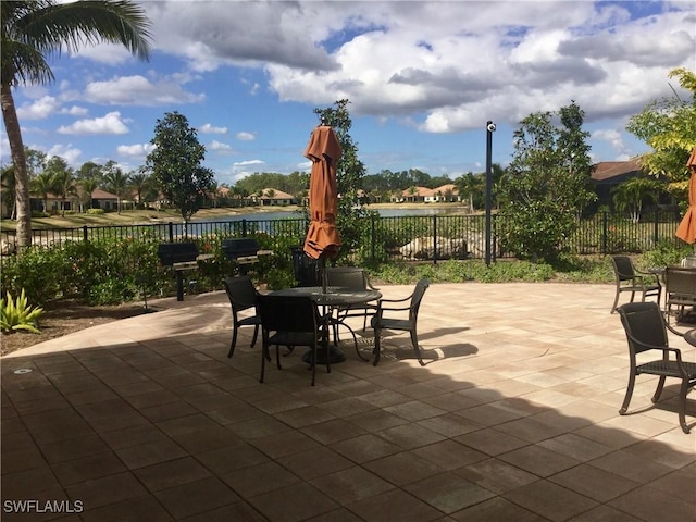 view of patio with outdoor dining area and fence