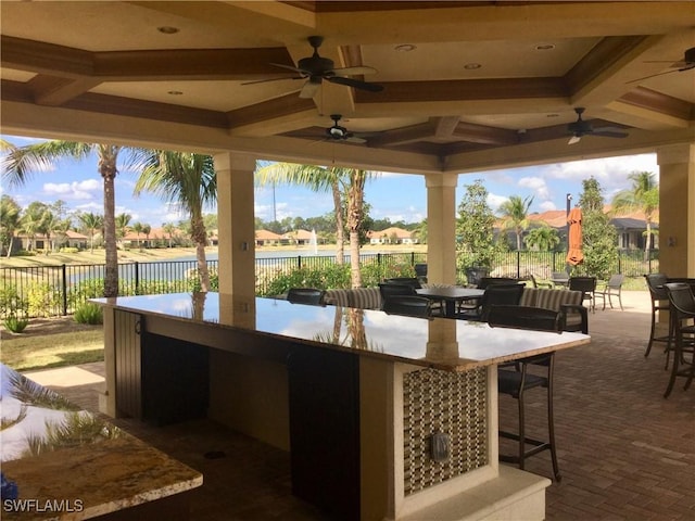 view of patio featuring outdoor dining area, fence, and outdoor dry bar