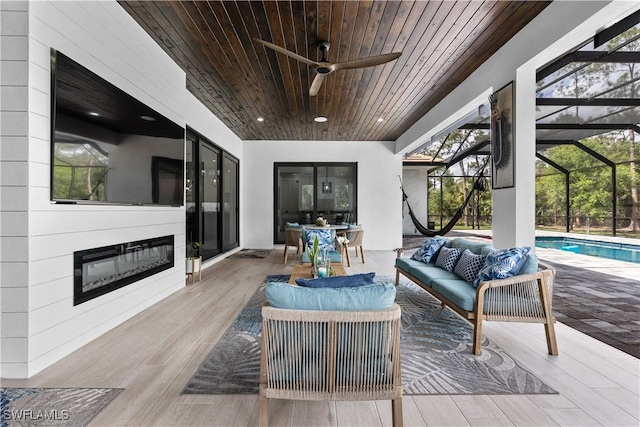 view of patio / terrace with an outdoor pool, glass enclosure, an outdoor hangout area, and a ceiling fan