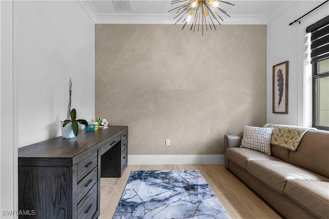 living room featuring ornamental molding, visible vents, a notable chandelier, and light wood finished floors