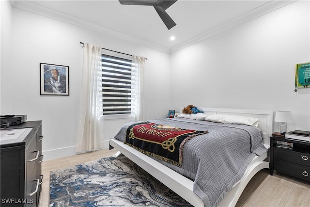 bedroom featuring baseboards, ceiling fan, crown molding, light wood-type flooring, and recessed lighting