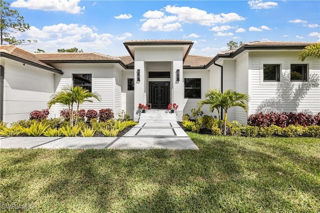 doorway to property with a yard