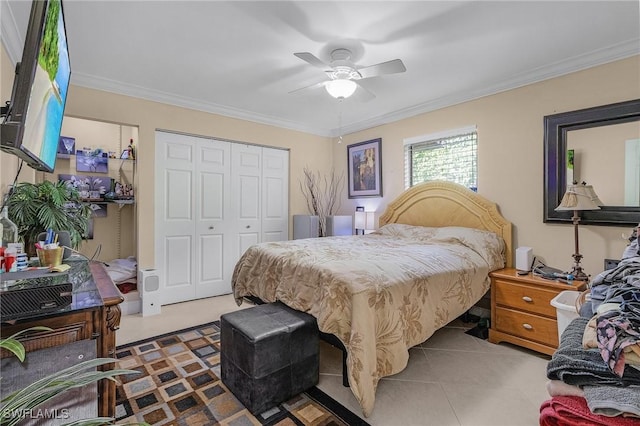 tiled bedroom featuring a ceiling fan, a closet, and crown molding