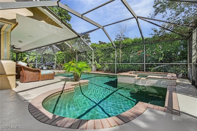 view of swimming pool featuring a patio area, a lanai, and a pool with connected hot tub