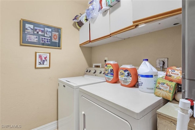 laundry room with cabinet space and washing machine and clothes dryer