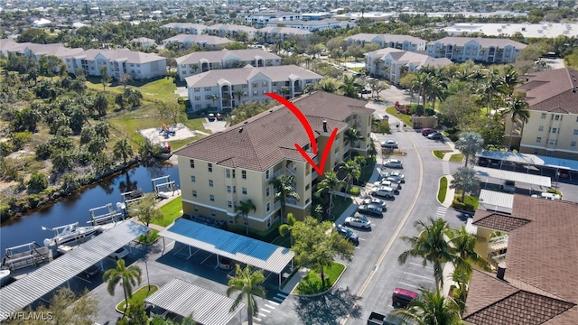 bird's eye view featuring a water view and a residential view