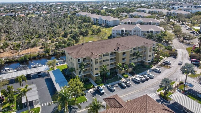 birds eye view of property featuring a residential view and a water view