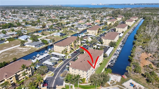 drone / aerial view featuring a residential view and a water view