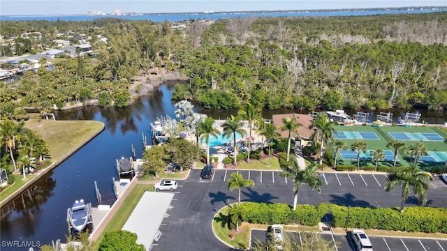 bird's eye view with a water view and a forest view