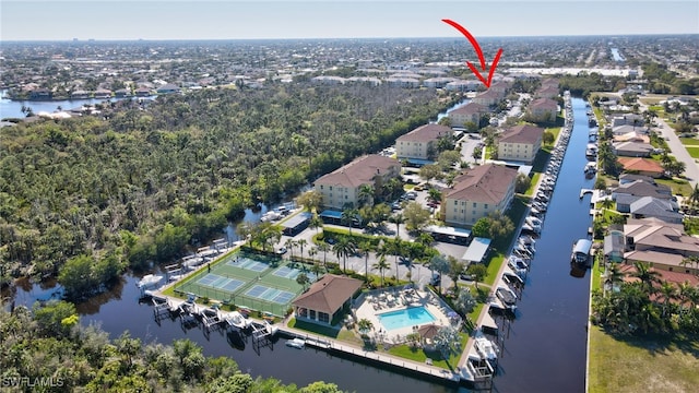 drone / aerial view featuring a water view and a residential view